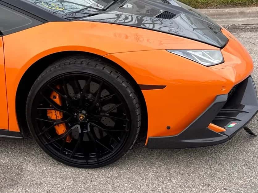 Orange Lamborghini Huracán, front wheel and nose, at delivery