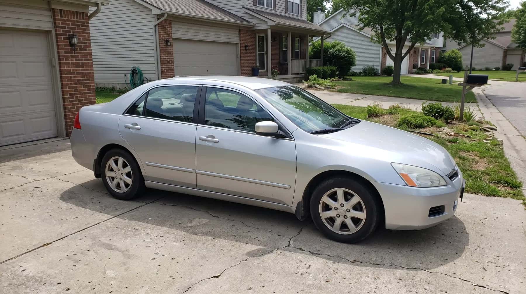 Silver sedan in a suburban driveway